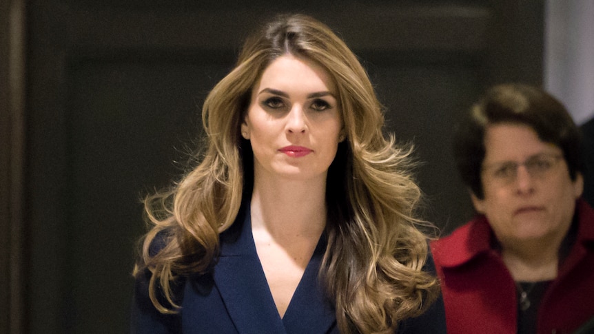 Hope Hicks looks at the camera lense as she walks down a corridor