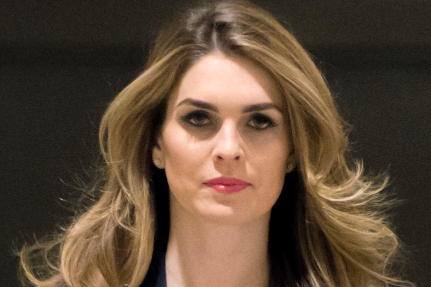 Hope Hicks looks at the camera lense as she walks down a corridor