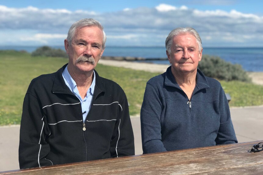 Wayne Iremonger and Peter Morris sit at the park table.