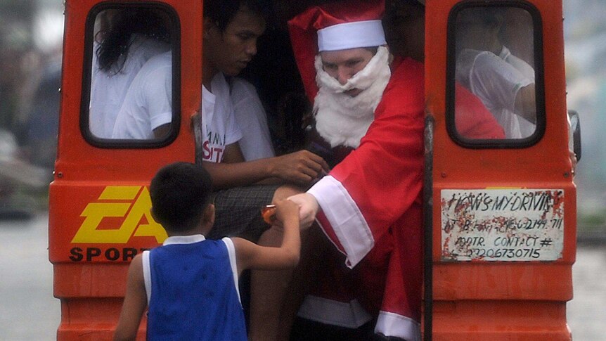 Santa distributes presents in the Philippines.