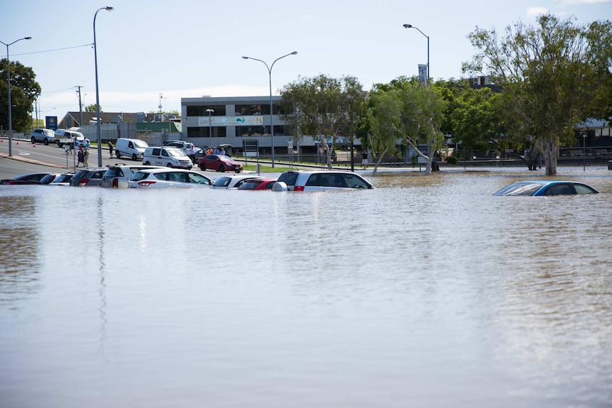 Beenleigh flood waters inundate vehicles