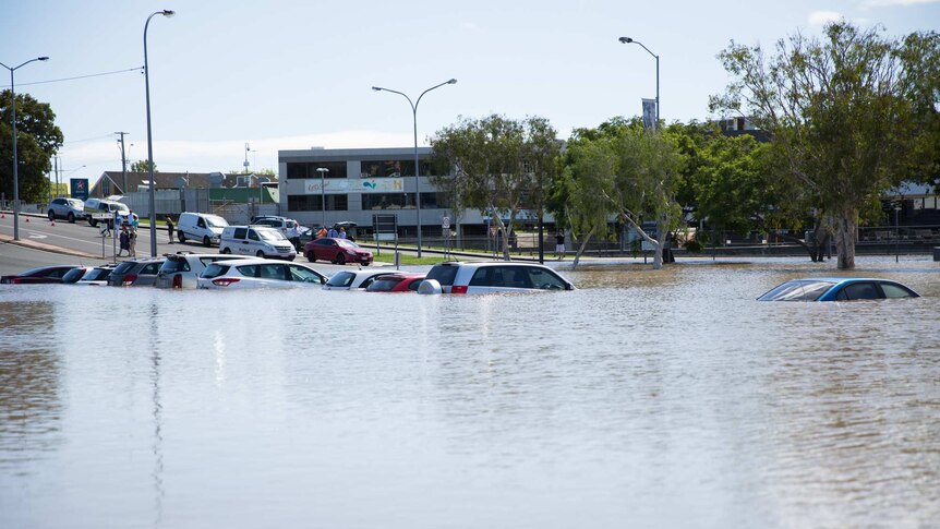 Beenleigh flood waters inundate vehicles