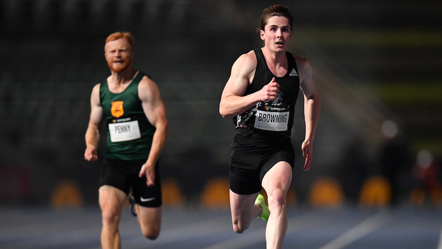 A male sprinter runs in the final of the 100 metres at the national track and field championships.