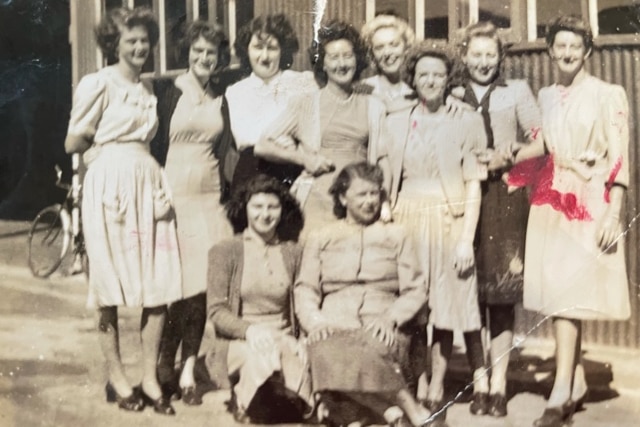 Women workers support the WWII effort outside a factory.