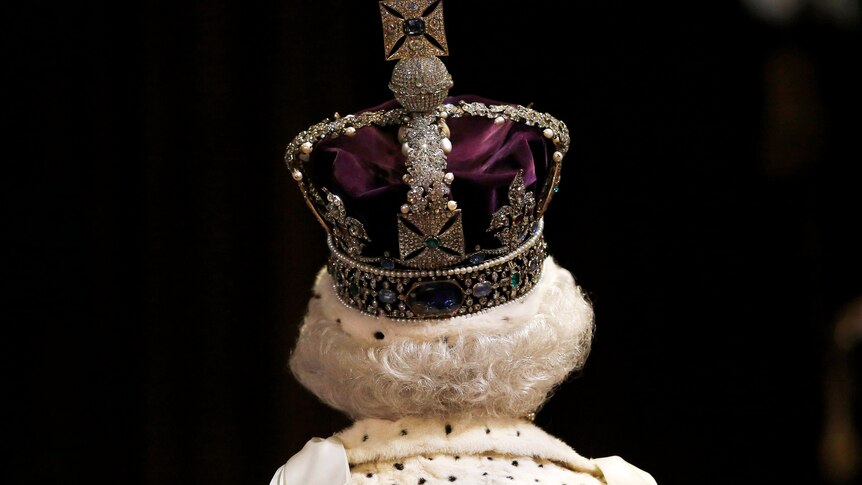 Queen Elizabeth II faces away from the camera wearing a crown