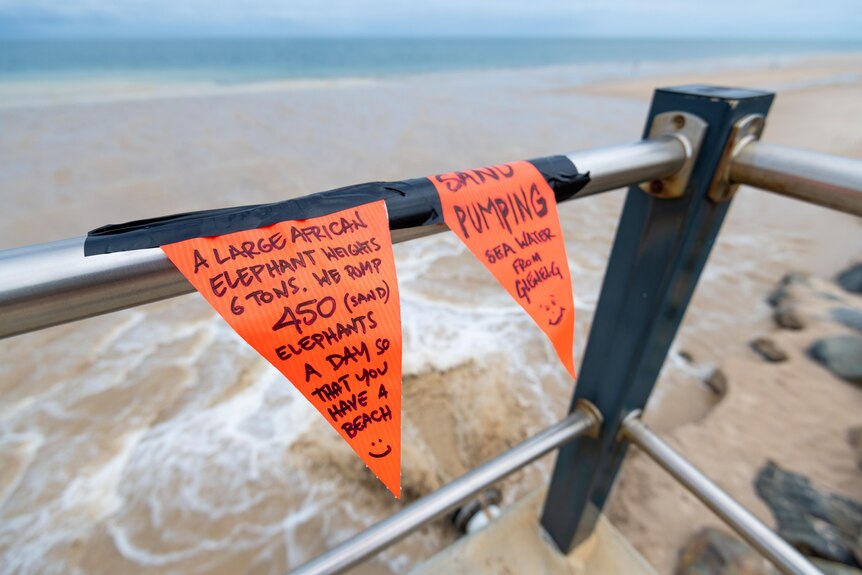 Public messages about sand pumping attached to a metal platform.