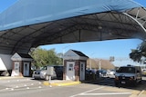 Cars drive through the entry gates of Naval Air Base Station in Pensacola.