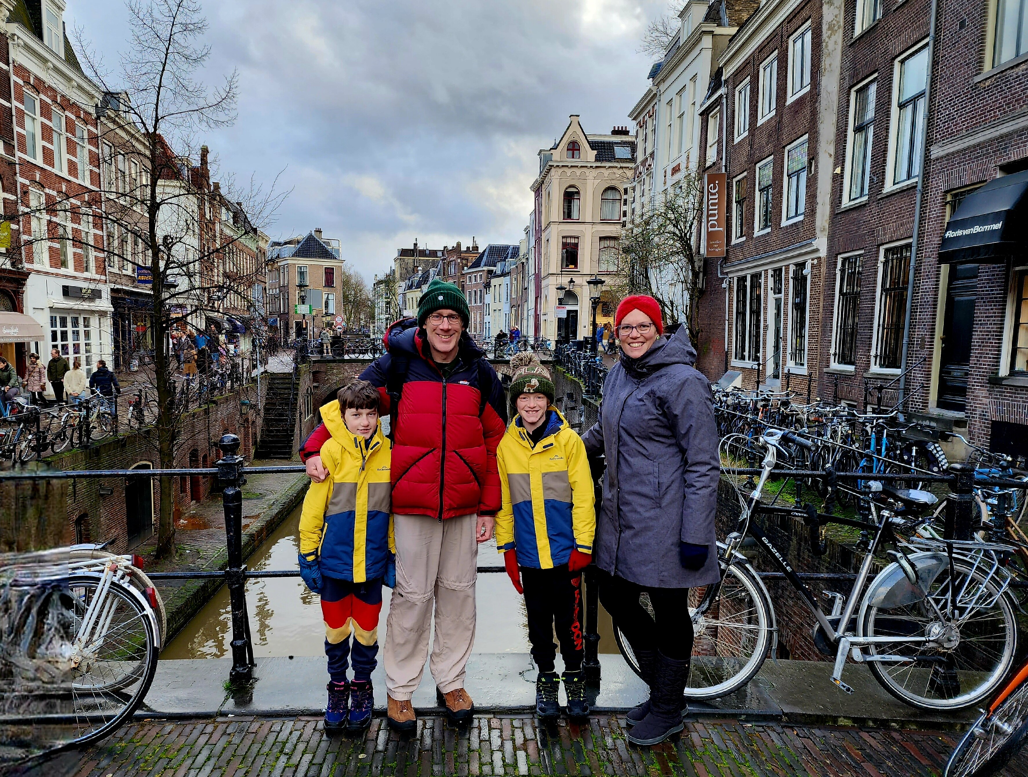 Erin Parker and her family stand on a bridge while travelling overseas