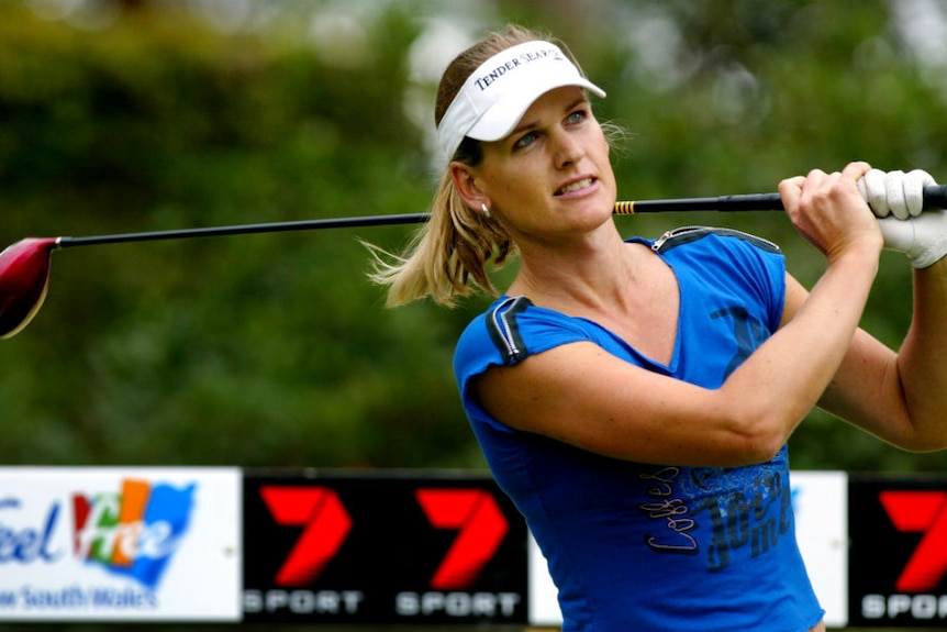 Mianne Bagger watches her shot from the tee with her golf club slung over her shoulder.