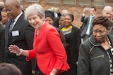 British Prime Minister Theresa dances with children at a school in South Africa.
