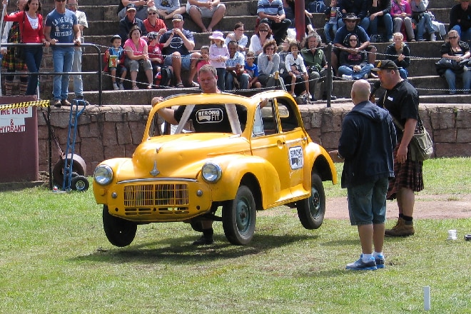 A man carrying a yellow car in a competition