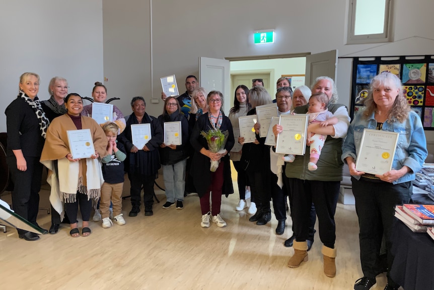 Ngarrindjeri language graduates hold their teaching qualification certificates.