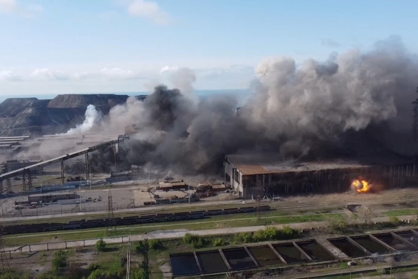 Aerial view of smoke coming out of large industrial area with fires.