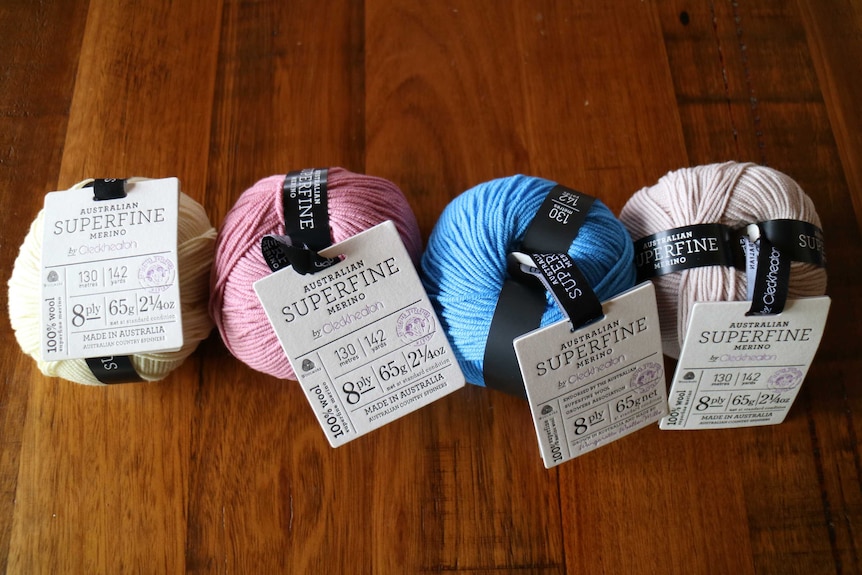 four balls of superfine merino knitting yarn