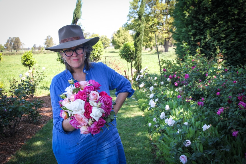 Lucy Marshall hold a large bunch of freshly cut roses.