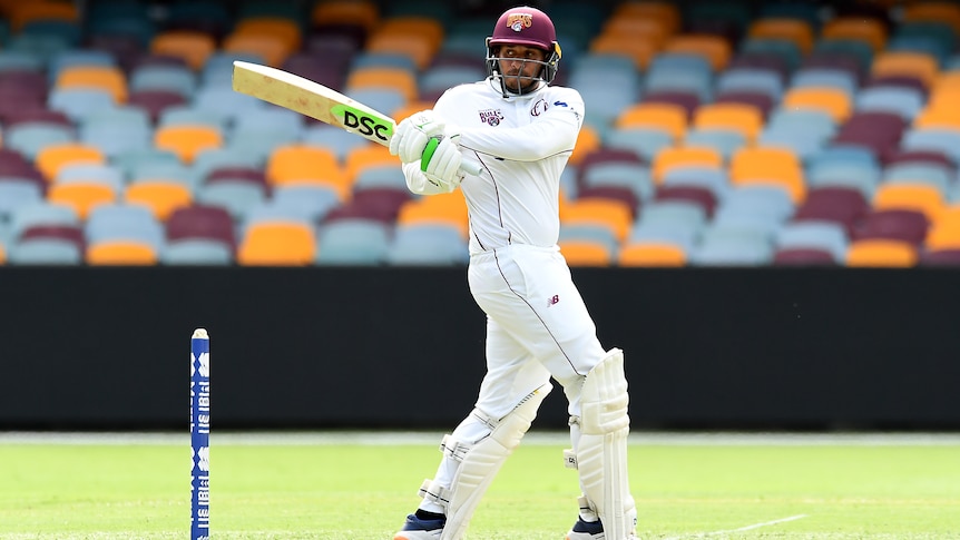 A Queensland Sheffield Shield batter plays a pull shot against Western Australia at the Gabba.
