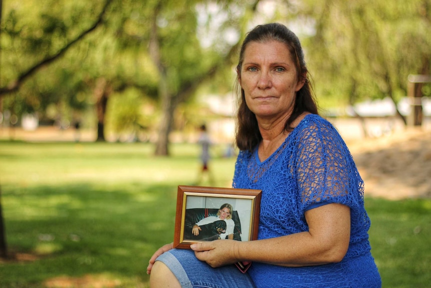 Angela Van Goor holding a photo of her deceased son, Hayden.