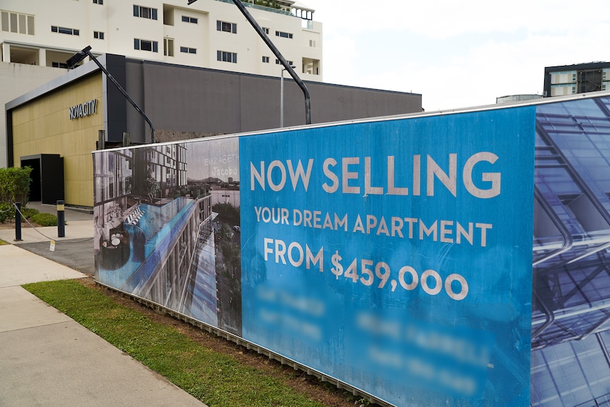 Construction fence advertising "your dream apartment" from $459,000.
