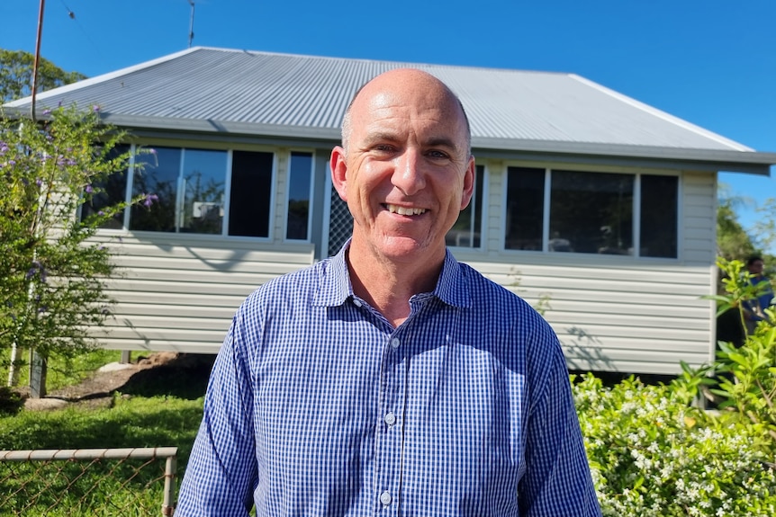 man in front of a house