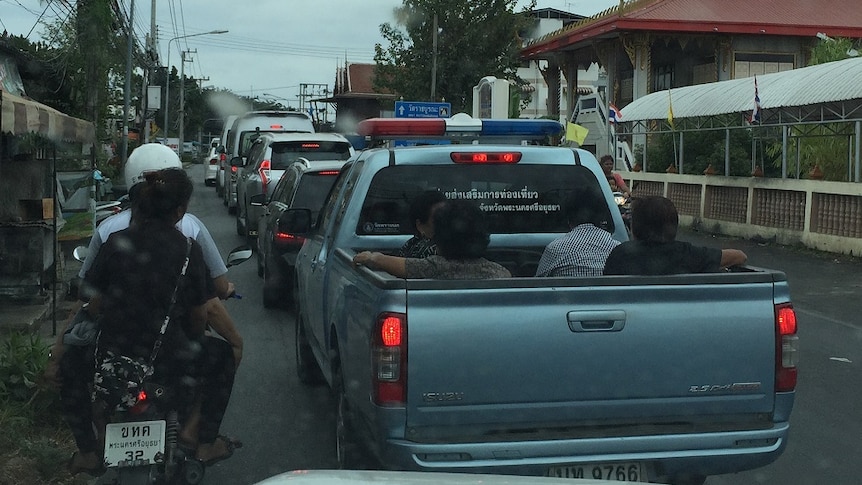 Thais ride in the back of a truck