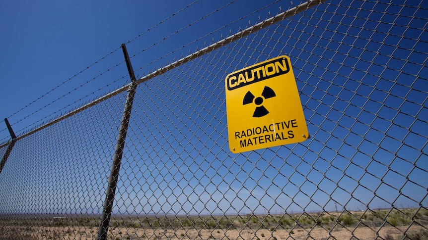 Nuclear warning sign on a fence.