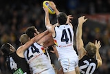 Mitch McGovern takes a huge pack mark for Adelaide against Collingwood at the MCG.