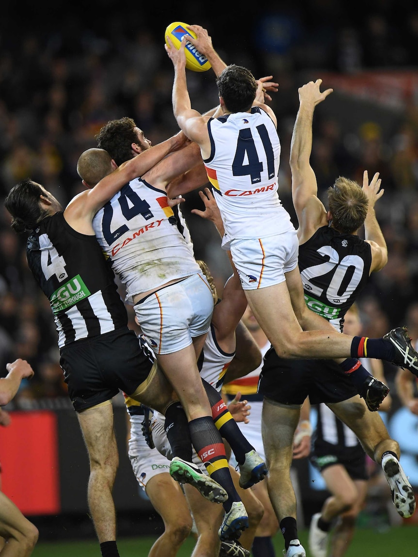 Mitch McGovern takes a huge pack mark for Adelaide against Collingwood at the MCG.