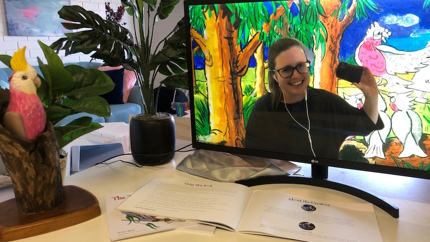 Kim appears on a computer screen with painted galahs behind her