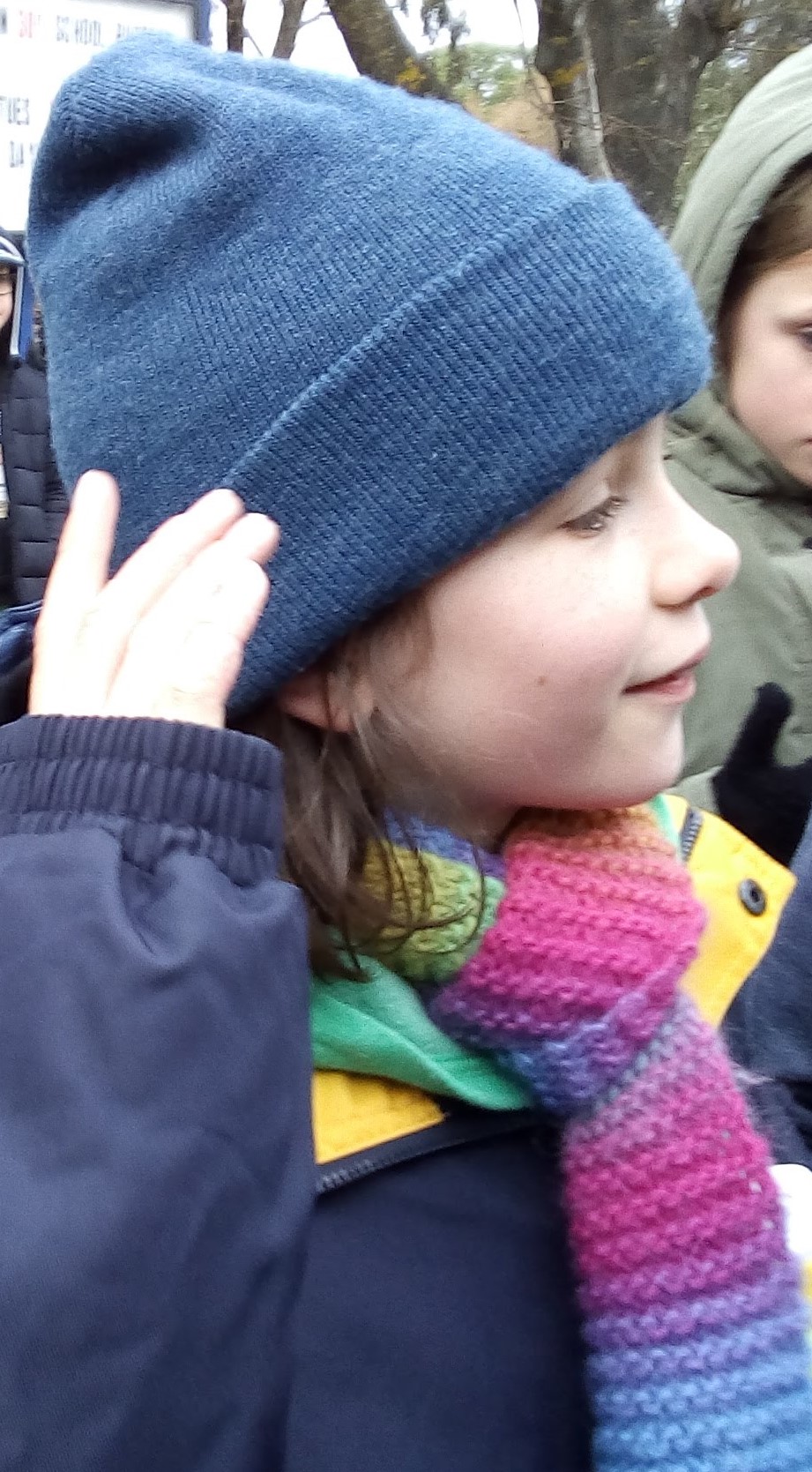 Young girl wearing a rainbow scarf
