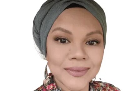 A photo of Dr Nora, who wears a turban-style hijab.