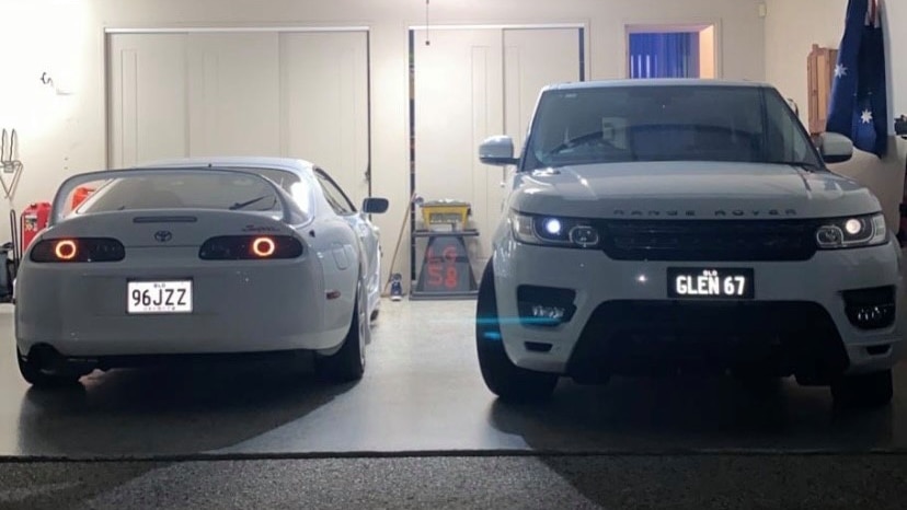 a white Range Rover and white Toyota Supra in a garage