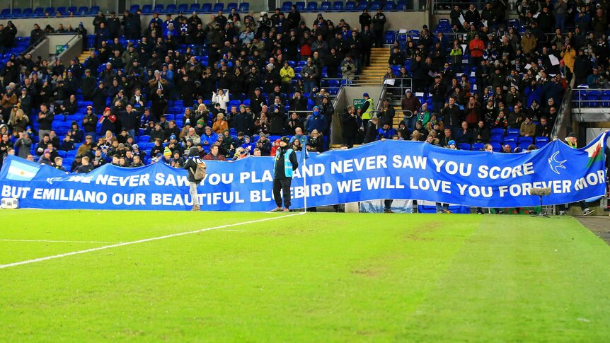 Fans hold a banner in tribute to Italian footballer Emiliano Sala at a Premier League game.