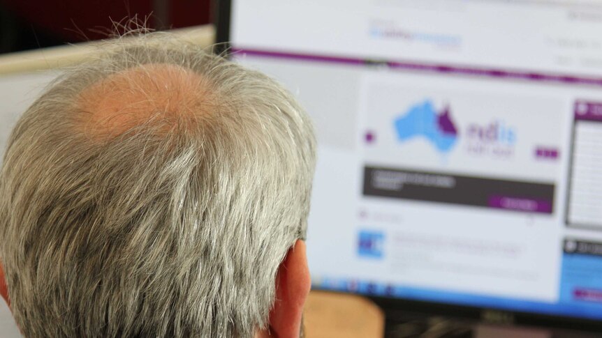 Man looks at the NDIS website