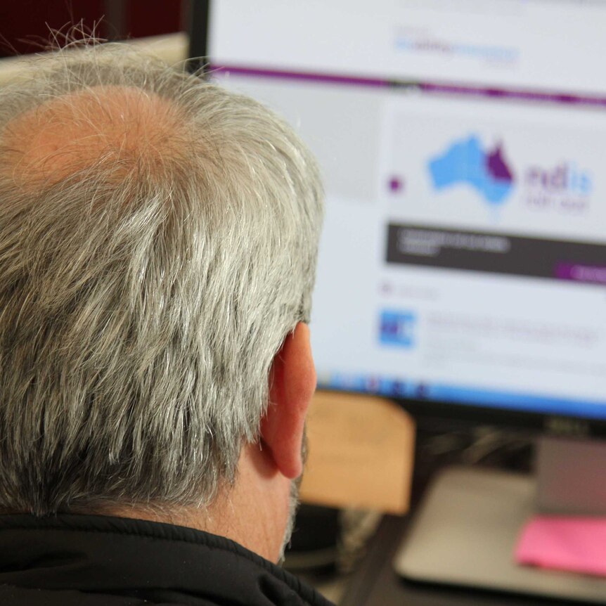 Man looks at the NDIS website