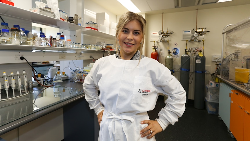 Environmental biologist Marianne Haines standing with her hands on hips in her lab at University.