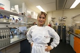 Environmental biologist Marianne Haines standing with her hands on hips in her lab at University.