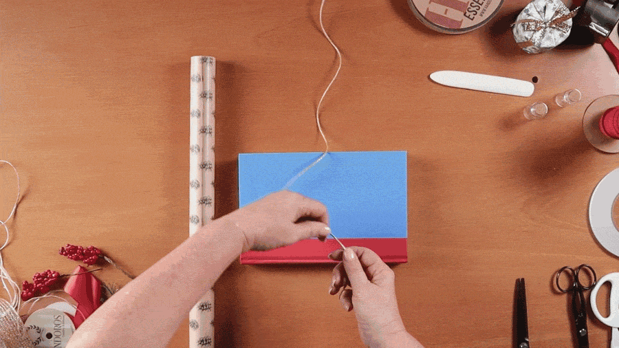 GIF of string winding around a book to estimate how much wrapping paper to use when wrapping gifts.