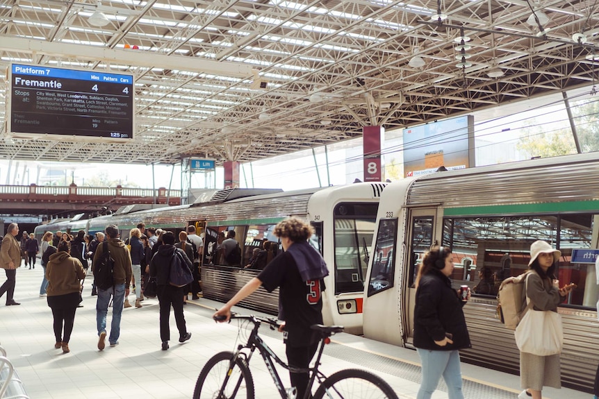 Passengers board a train in Perth.