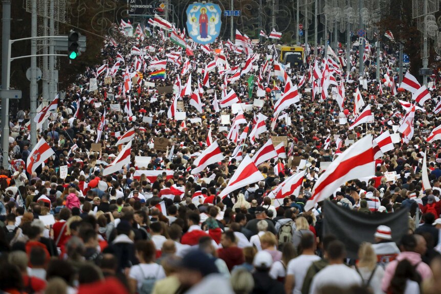 Crowd of people with red and white flags