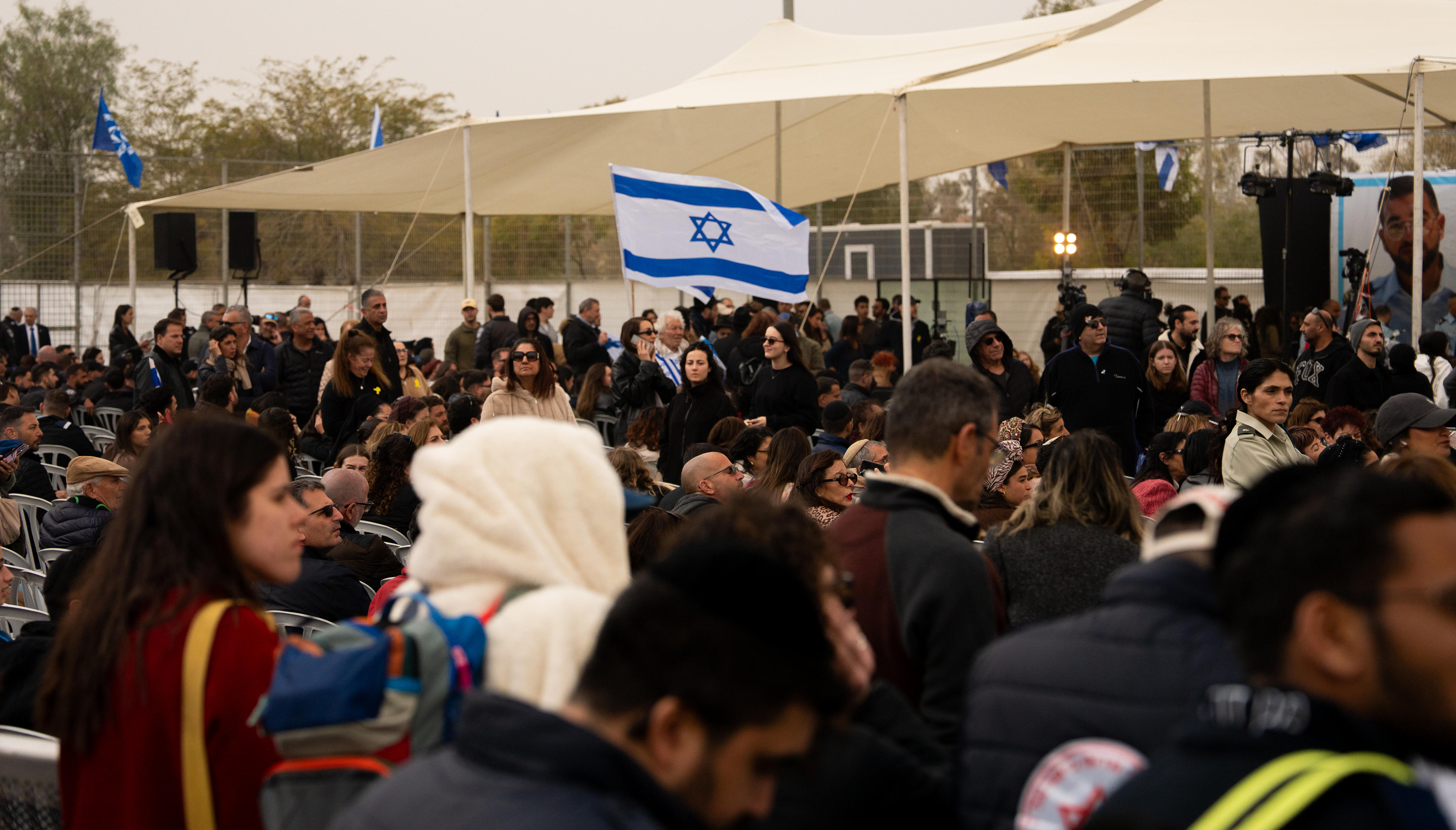 Uma foto de dezenas de pessoas sob tendas para comemorar o funeral de Gvili.
