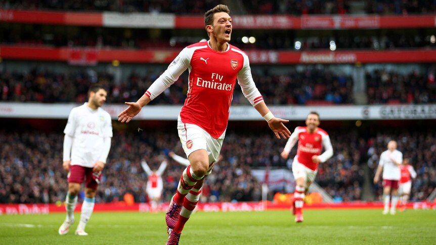 Mesut Oezil of Arsenal celebrates after scoring his team's second goal during