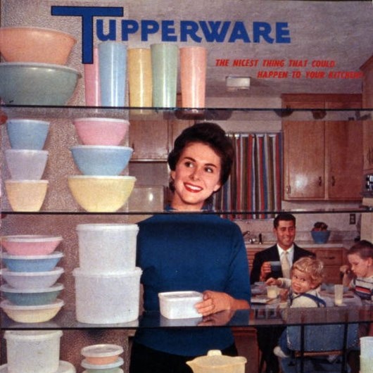 A Tupperware advertisement showing a 50s woman looking at a shelf of Tupperware.