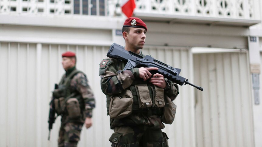 French soldier patrols outside of Jewish school