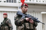 French soldier patrols outside of Jewish school