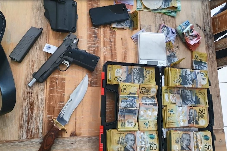 Money and weapons lying on a table