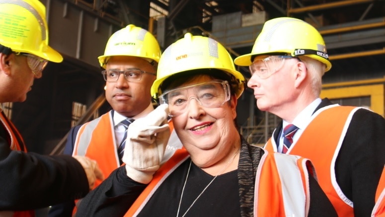 Whyalla mayor Lyn Breuer in a hard hat at the steelworks, with new owner Sanjeev Gupta and MP John Rau in the background.