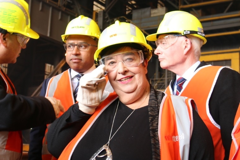 Whyalla mayor Lyn Breuer in a hard hat at the steelworks, with new owner Sanjeev Gupta and MP John Rau in the background.