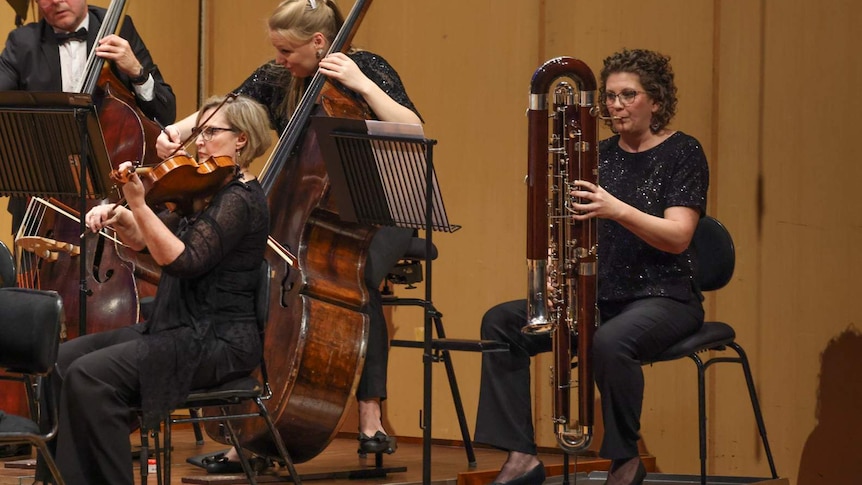 Queensland Symphony Orchestra's principal contrabassoonist, Claire Ramuscak, playing contrabassoon in the bass section.