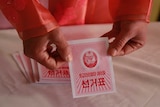 An electoral worker shows a ballot during North Korea's election.