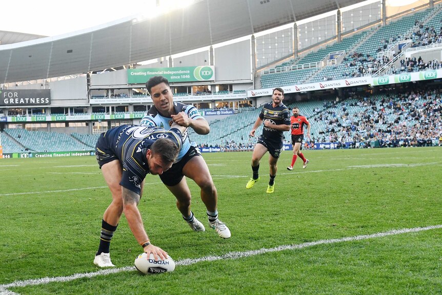 Kyle Feldt (left) of the Cowboys scores a try in the elimination final against Cronulla.